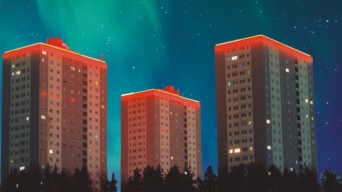 A digital image of three tower blocks against a sky lit by the northern lights.