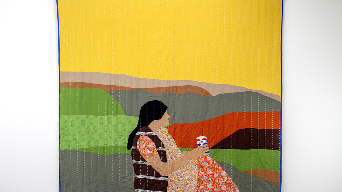 A large textile featuring a figure in a rural landscape drinking a Pepsi.