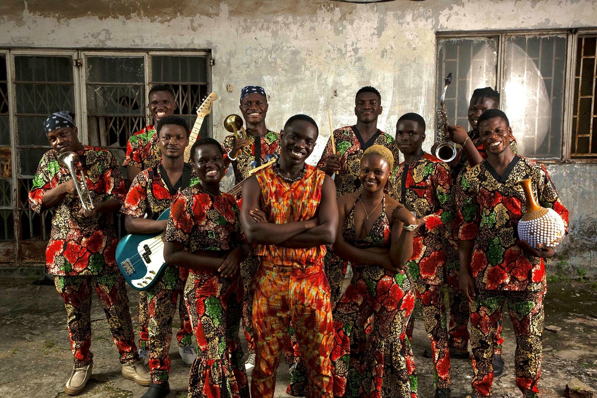 A full band holding their instruments.