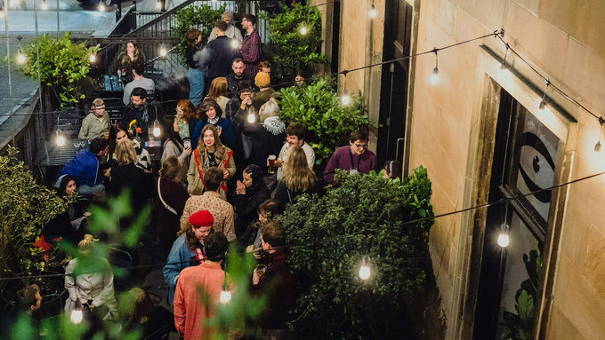 The terrace bar of Third Eye Bar is full of people, animatedly talking.