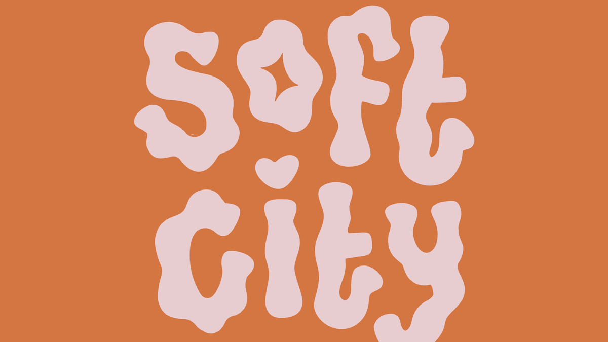 An orange image with pink text reading "Soft City".