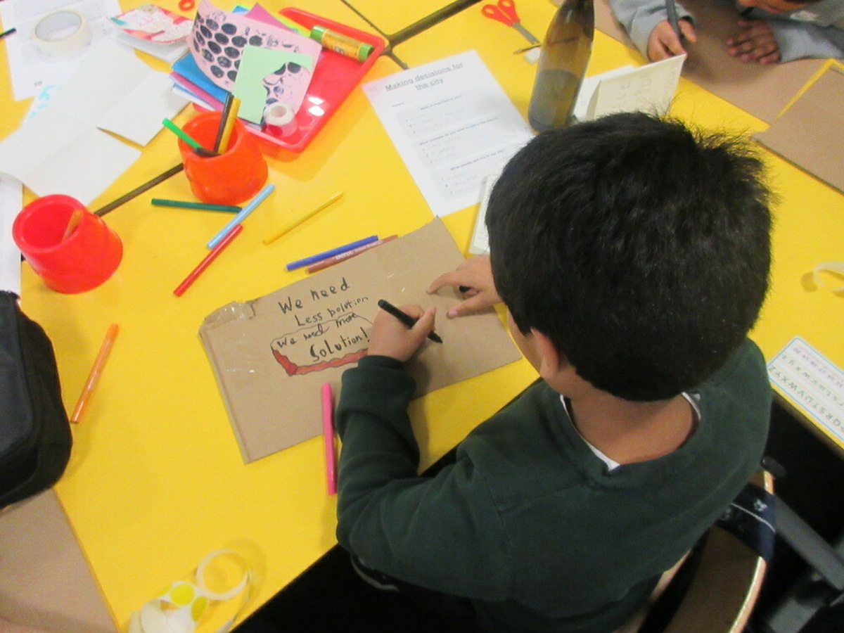 A child engages in collage.